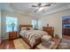 Spacious main bedroom featuring a tray ceiling, hardwood floors, and ensuite access at 1812 Sam Smith Rd, Fort Mill, SC 29708