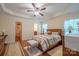 Bright main bedroom with wood floors, ceiling fan, and access to a walk-in closet at 1812 Sam Smith Rd, Fort Mill, SC 29708