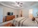 This well-lit main bedroom features hardwood floors, ceiling fan and ensuite bath at 1812 Sam Smith Rd, Fort Mill, SC 29708
