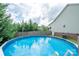 Enjoy a cool view of the in-ground pool surrounded by a privacy fence and lush trees at 1812 Sam Smith Rd, Fort Mill, SC 29708
