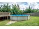 This is an above ground swimming pool surrounded by lush green trees and green grass at 1812 Sam Smith Rd, Fort Mill, SC 29708