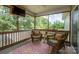 Enjoy this outdoor screened-in porch perfect for relaxing with outdoor seating and a ceiling fan at 1812 Sam Smith Rd, Fort Mill, SC 29708