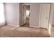 Bright bedroom featuring neutral walls, carpet, and white doors at 19057 Coachmans Trce, Cornelius, NC 28031