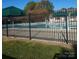 Community pool surrounded by a black fence and green umbrellas, creating a refreshing retreat at 19057 Coachmans Trce, Cornelius, NC 28031