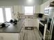 Bright kitchen with white cabinets, stainless steel appliances, and stylish countertops at 19057 Coachmans Trce, Cornelius, NC 28031