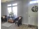 Bright living room with natural light, neutral paint, comfortable chairs, and stylish decor at 19057 Coachmans Trce, Cornelius, NC 28031