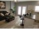 Bright living room features modern decor, white cabinets, and stylish bar stool seating at the kitchen counter at 19057 Coachmans Trce, Cornelius, NC 28031