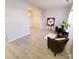 Spacious living room with hardwood floors, comfortable seating, and natural light from the window at 19057 Coachmans Trce, Cornelius, NC 28031