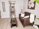 Cozy living room featuring a leather couch, decorative artwork, and neutral wall color at 19057 Coachmans Trce, Cornelius, NC 28031