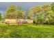 Charming single story house with a fenced yard, deck, and play area surrounded by mature trees at 2006 Kollege Ln, Crouse, NC 28033