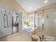Bright bathroom features a soaking tub, glass shower, and neutral tones, creating a spa-like ambiance at 20132 Tailwind Ln, Cornelius, NC 28031