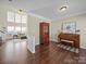 Spacious room with high ceilings, a piano, and hardwood floors at 20132 Tailwind Ln, Cornelius, NC 28031