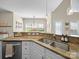 Open kitchen design with granite counters and stainless steel sink at 20132 Tailwind Ln, Cornelius, NC 28031