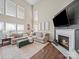 Spacious living room featuring a fireplace, sectional sofa, and large windows at 20132 Tailwind Ln, Cornelius, NC 28031