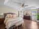 Spacious main bedroom features a tray ceiling, ceiling fan, hardwood floors, and ample natural light at 20132 Tailwind Ln, Cornelius, NC 28031