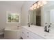 Spacious bathroom with double vanity, soaking tub, large mirror, and modern fixtures with neutral paint at 2104 Congress Ct, Kannapolis, NC 28083