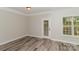This bedroom features beautiful floors, a door to the exterior and a large window for plenty of natural light at 2104 Congress Ct, Kannapolis, NC 28083