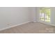 This bedroom features neutral carpeting and a large window which provides plenty of natural light at 2104 Congress Ct, Kannapolis, NC 28083