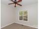 This bedroom features neutral carpeting, a window with a view, and a ceiling fan at 2104 Congress Ct, Kannapolis, NC 28083