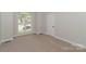 Bright bedroom with large window, neutral carpeting, and ample natural light with fresh paint at 2104 Congress Ct, Kannapolis, NC 28083