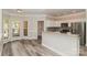 Modern kitchen with stainless steel appliances, white cabinetry, and a breakfast bar overlooking dining area at 2104 Congress Ct, Kannapolis, NC 28083