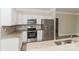 Elegant kitchen with stainless steel appliances, white cabinets, and granite countertops with modern backsplash at 2104 Congress Ct, Kannapolis, NC 28083
