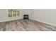 Bright living room with a fireplace, large window, and modern gray flooring throughout at 2104 Congress Ct, Kannapolis, NC 28083