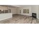 Open-concept living room featuring modern gray flooring, fireplace, and seamless connection to the kitchen at 2104 Congress Ct, Kannapolis, NC 28083