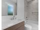 Modern bathroom with a stylish vanity, sleek fixtures, and a combined shower-tub with tile surround creating a spa-like experience at 215 Keswick Ave, Charlotte, NC 28206