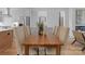 Contemporary dining space featuring a wooden table with seating and a view into the living area at 215 Keswick Ave, Charlotte, NC 28206