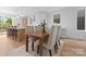 Inviting dining area with wooden table, neutral chairs, and an open view to the modern kitchen at 215 Keswick Ave, Charlotte, NC 28206