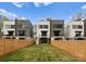 Townhome exterior showing deck, grassy backyard, and privacy fence at 215 Keswick Ave, Charlotte, NC 28206