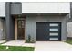 Front exterior view of new modern townhome with garage and modern front door at 215 Keswick Ave, Charlotte, NC 28206