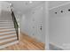 Hallway with stairs, mudroom storage, and hardwood floors, offering a welcoming entrance at 215 Keswick Ave, Charlotte, NC 28206