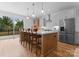 Bright, modern kitchen with stainless steel appliances, island seating, and sliding glass doors to the outside at 215 Keswick Ave, Charlotte, NC 28206