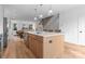 Spacious kitchen island with sink, dishwasher, seating, and an open view of the living area at 215 Keswick Ave, Charlotte, NC 28206