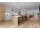 Open-concept kitchen with island seating, modern appliances, and an open floor plan to dining area at 215 Keswick Ave, Charlotte, NC 28206