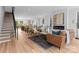 Open-concept living room featuring a fireplace, modern furniture, and stairs at 215 Keswick Ave, Charlotte, NC 28206