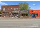 Street view of retail buildings with storefronts, displaying urban charm and commercial potential for business owners at 215 Keswick Ave, Charlotte, NC 28206