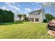 View of a large back yard and house from the edge of the property at 2409 Deberry Ct, Charlotte, NC 28213