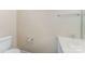 Well-lit half bathroom with white fixtures, toilet, and sink at 2409 Deberry Ct, Charlotte, NC 28213