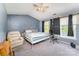 Spacious bedroom features carpet, a ceiling fan, two windows, and room to relax at 2409 Deberry Ct, Charlotte, NC 28213