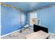 Cozy bedroom featuring blue walls, a window for natural light, and comfortable carpeting at 2409 Deberry Ct, Charlotte, NC 28213