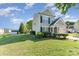 Two-story home with siding, a well-manicured lawn, and lush landscaping at 2409 Deberry Ct, Charlotte, NC 28213