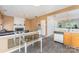 Open-concept floor plan with the kitchen open to a living and dining area at 2409 Deberry Ct, Charlotte, NC 28213