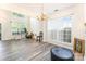 Open floor plan living area featuring a vaulted ceiling, large windows, and neutral decor at 2409 Deberry Ct, Charlotte, NC 28213