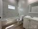 Bright bathroom showcasing a tub with tiled walls, a vanity, and modern fixtures at 312 W Henderson St, Salisbury, NC 28144