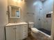 Bathroom featuring white vanity and walk-in shower with stylish gray and white tiling at 312 W Henderson St, Salisbury, NC 28144
