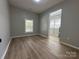 Spacious bedroom showcasing wood-look floors with a view into another sunlit room at 312 W Henderson St, Salisbury, NC 28144