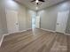 Spacious room features new wood-look flooring, neutral paint, ceiling fan and multiple doors at 312 W Henderson St, Salisbury, NC 28144